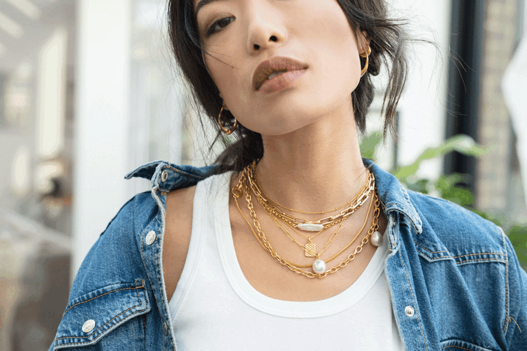 Model wearing Monica Vinader necklaces